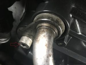 BMW oil cooler line bolt, on radiator side prior to removal.