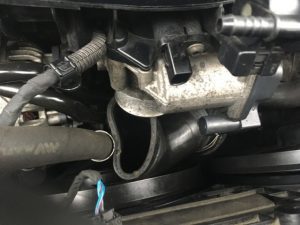 A partially removed Tiguan throttle body boot, clamps have been removed.