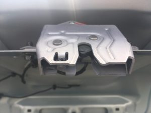 Latch assembly mounted on trunk frame.