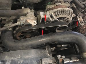 Serpentine Belt tensioner bolts and alternator bolts on a Subaru forester engine. 