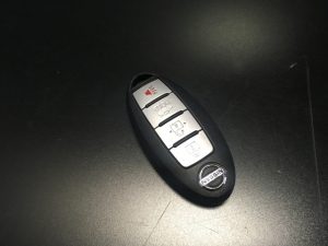 A Nissan / Infiniti Key Fob Battery on a black table. 