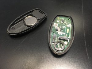 A dismantled Nissan / Infiniti Key Fob in two halves.