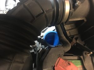 Refilling of Honda automatic transmission with transmission fluid using a long thin funnel.