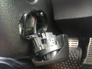 VW Engine button removed and hanging from electrical connector.