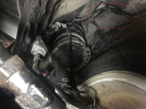 Hyundai Elantra with right front wheel well lining removed.