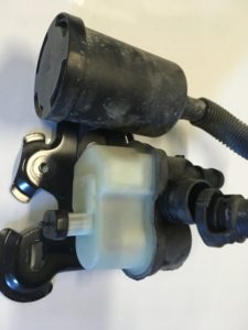 A new Volkswagen evaporation leak pump installed on housing bracket and ready to be installed on the car.