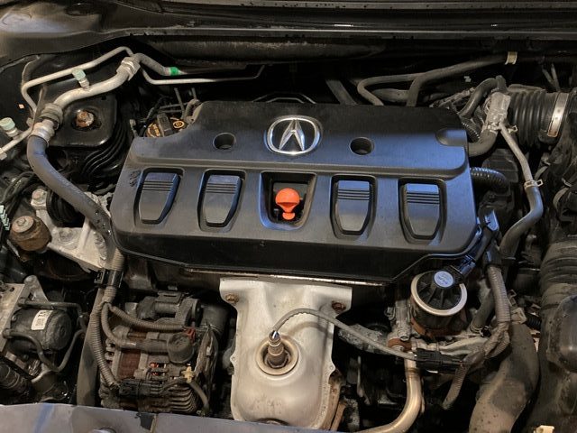 2015 Acura ILX 2.0L Engine bay, engine has a black cover.